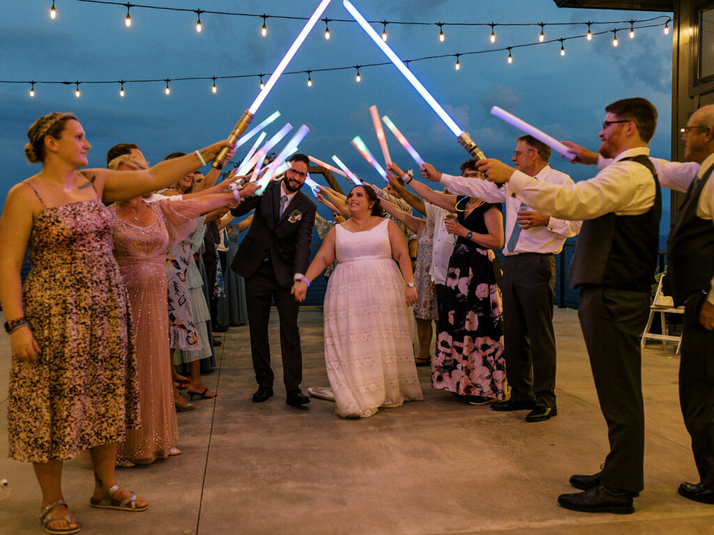 lightsaber unique wedding exit idea with bride and groom