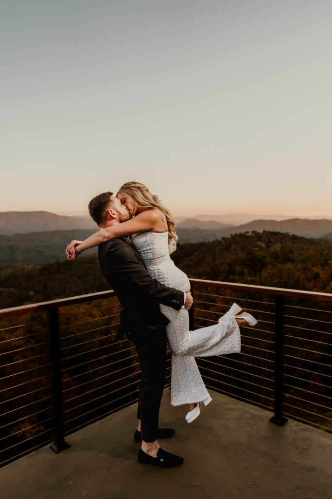 Couple embracing during golden hour at The Trillium, a luxury Smoky Mountain wedding venue, Husband sweeps her off her feet