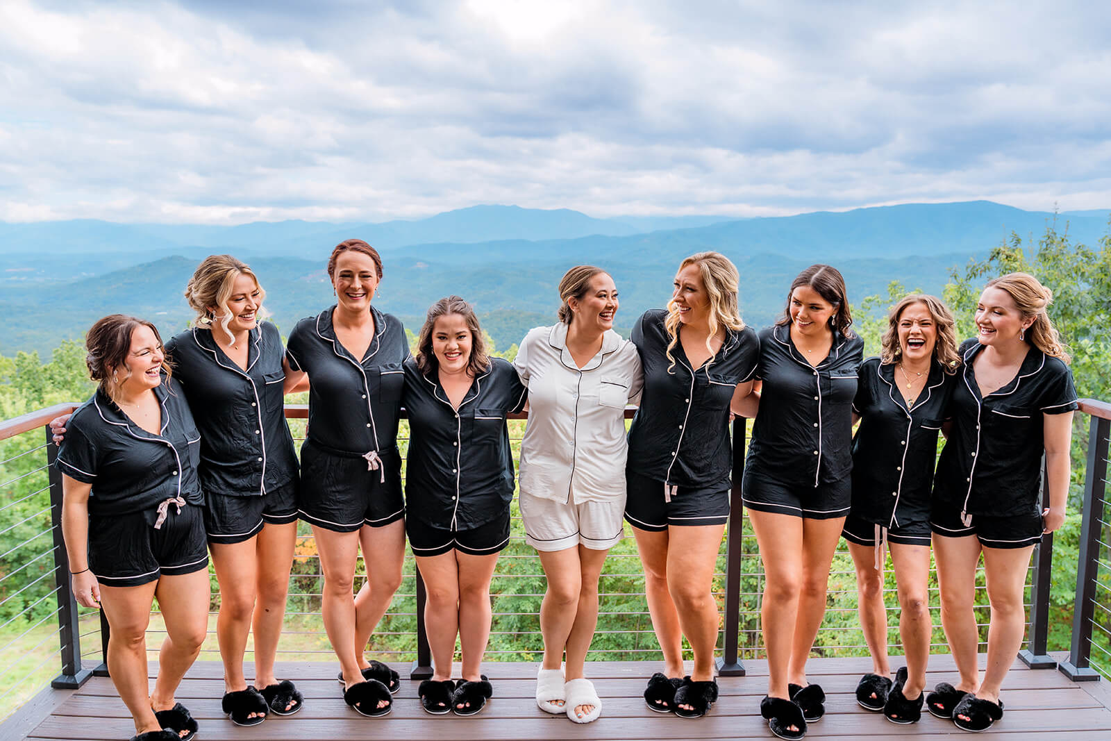 Bride and her bridesmaids on the private balcony in matching sets getting ready for her wedding day