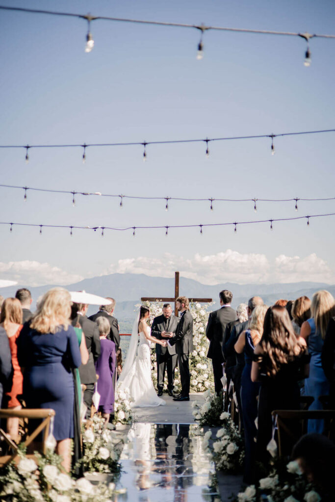Black and White destination wedding, cross arbor, wedding ceremony in the mountains, white wedding florals 